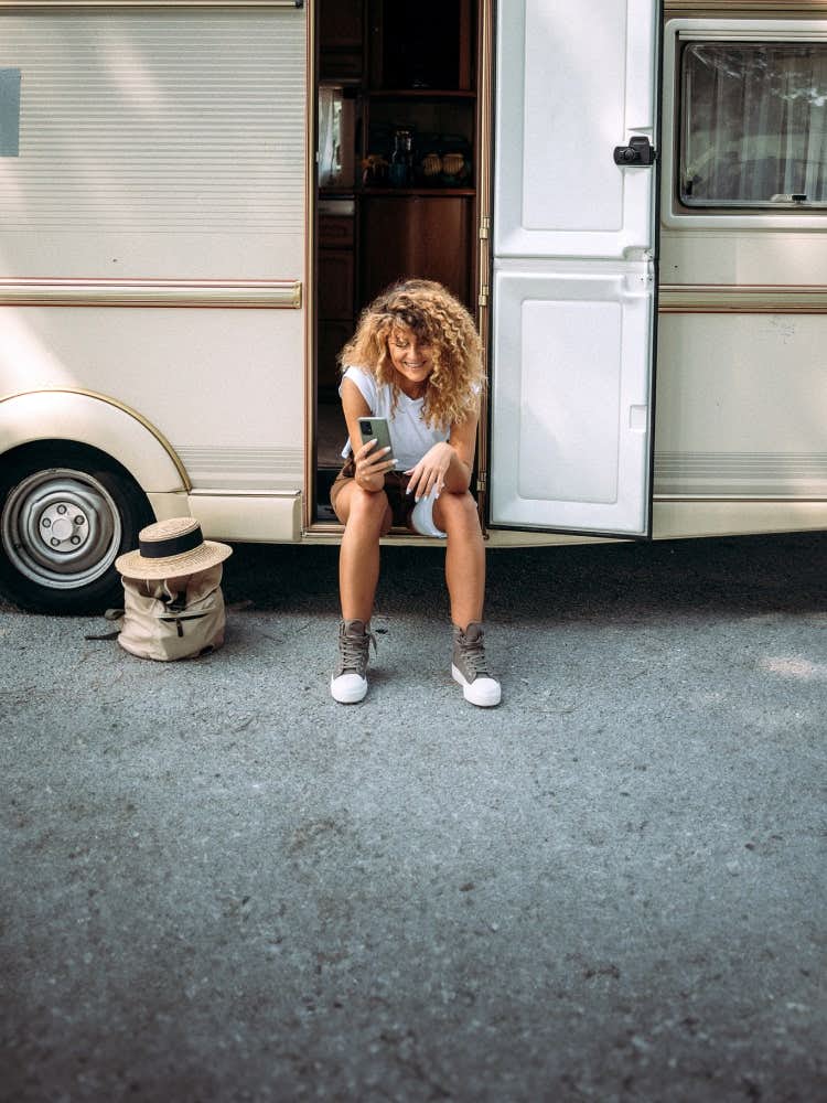 woman on phone outside the RV