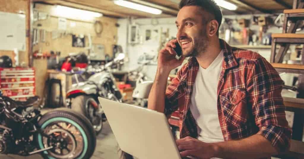 image of man talking on cell phone in a garage
